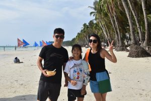 Students exploring the white beach of Boracay Island in the Philippines