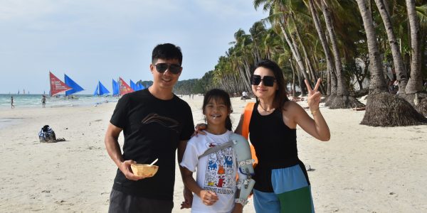 Students exploring the white beach of Boracay Island in the Philippines